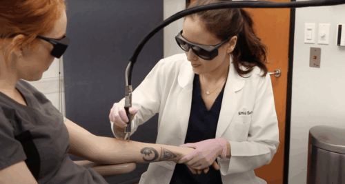 Dr. Monica Boen is applying Alexandrite and Fraxel Dual laser on a young woman;s arm for tattoo removal in San Diego, CA. 