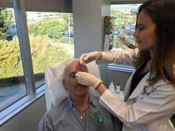 dermatologist treating wrinkles on an older male patient