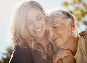 Image of a young woman side hugging an older woman to show compassion. Used for burn treatment in San Diego, CA.