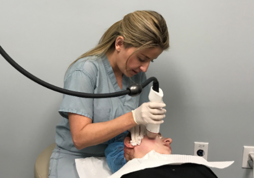 dermatologist performing a microneedling treatment on a patient from san diego