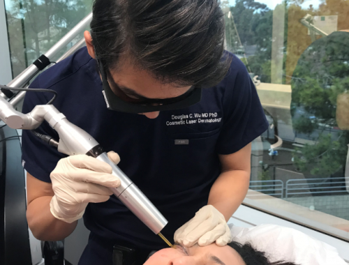 doctor treating the skin of an asian patient