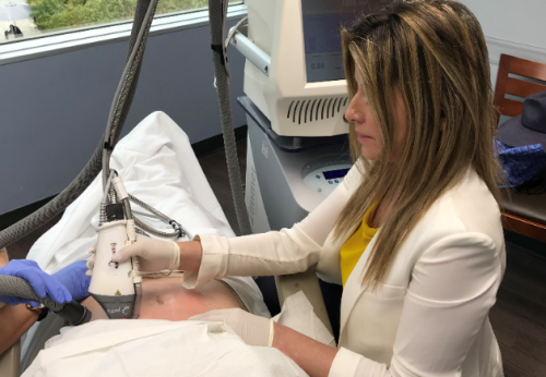 dermatologist performing fraxel repair treatment on a patient