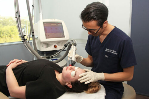 dermatologist, Dr. Douglas C. Wu performing a cosmetic laser treatment on a patient in San Diego