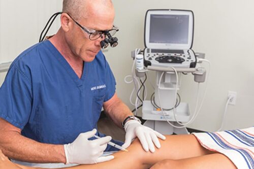 Dr. Goldman administering vein treatment for spider and varicose veins at our San Diego medspa