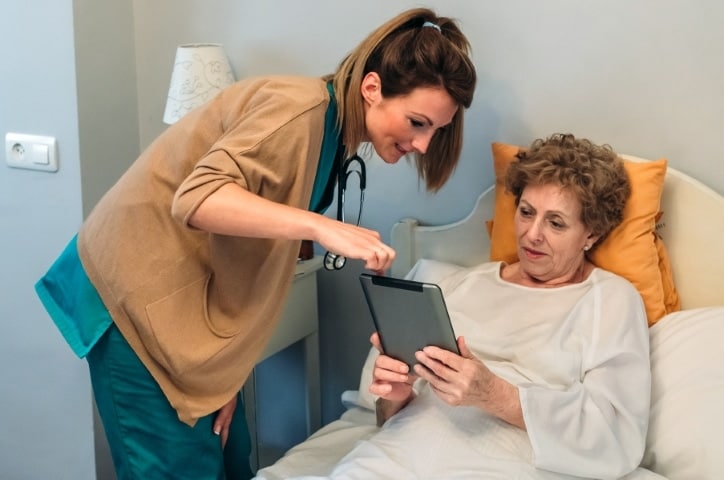 Our aesthetician Farzaneh interacts with a patient following a surgical procedure in San Diego